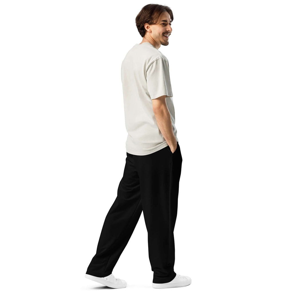 Man wearing Urban Halo black wide-leg joggers and a light-colored t-shirt, standing in a relaxed pose.